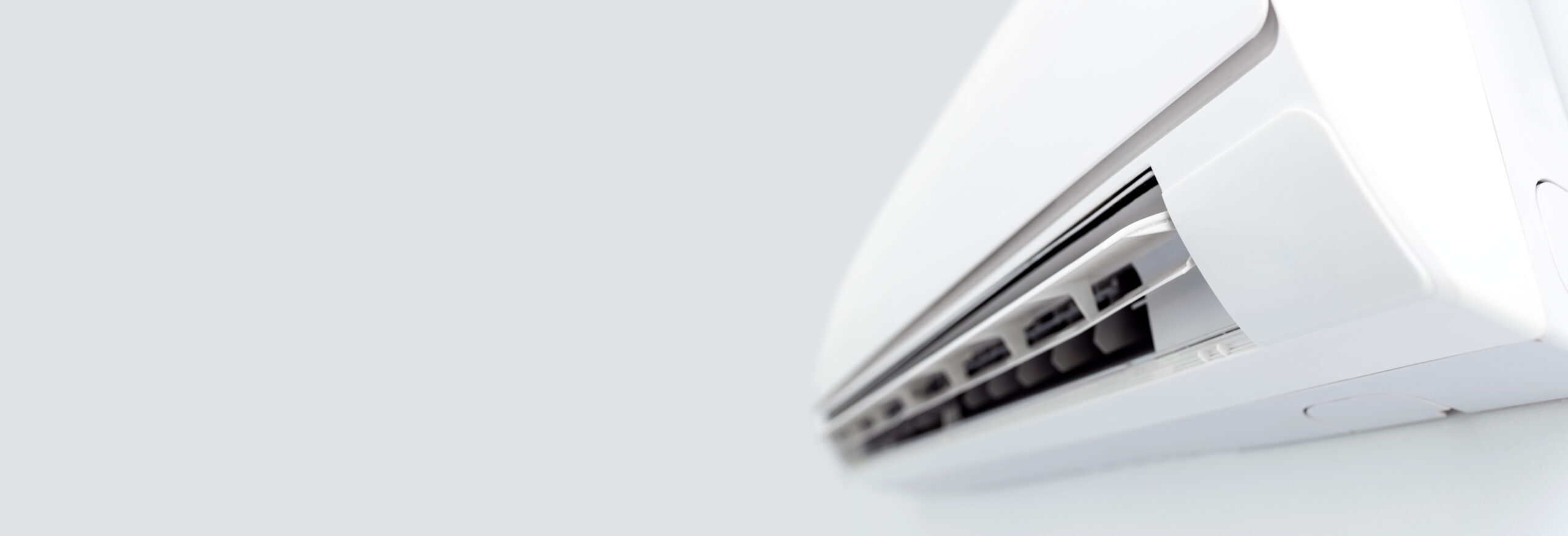 Air,Conditioner,Split,Hanging,On,The,Wall.,Cooling,Device,In